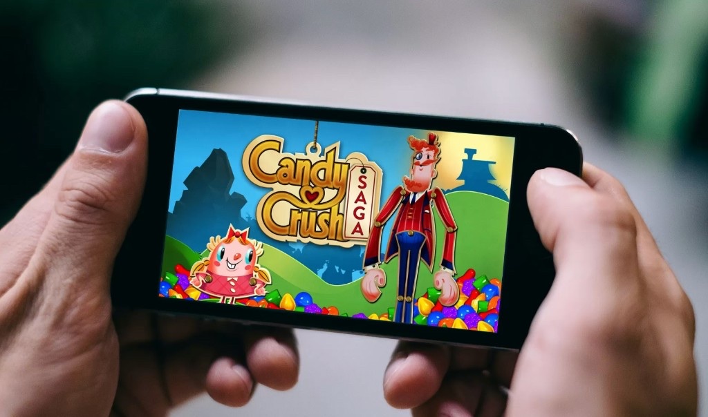 Candy Crush Saga on a phone — the player world King operates at a scale of 600 million.